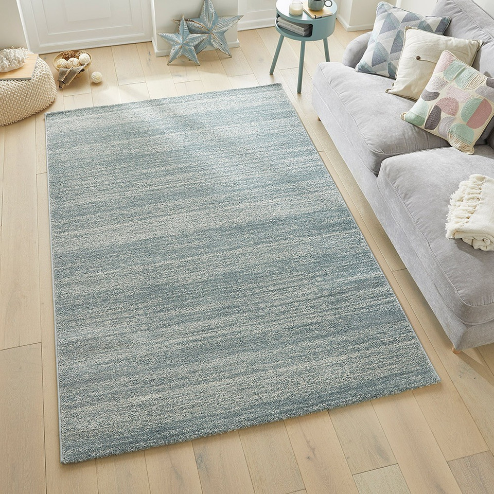 blue striped rug in a living room with matching decor
