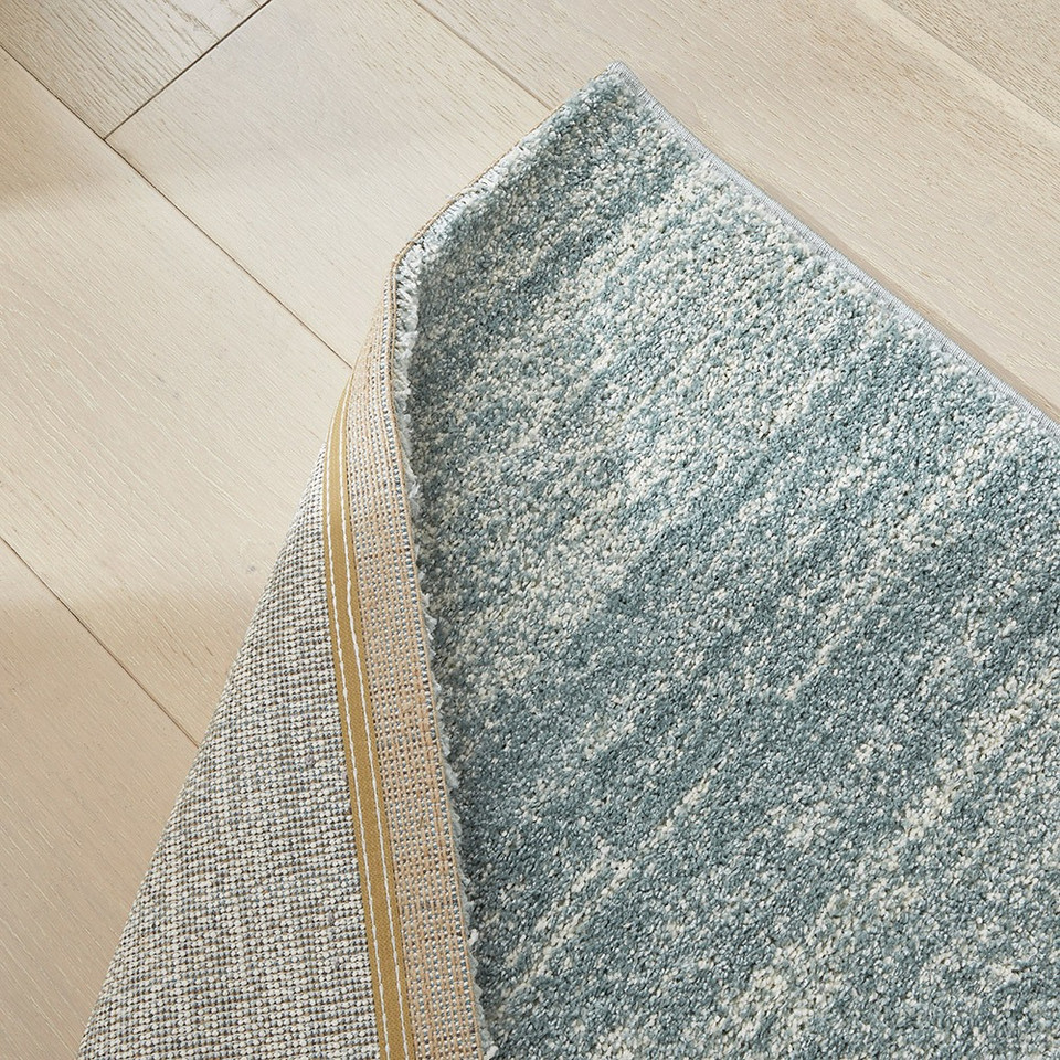 blue striped rug closeup corner fold