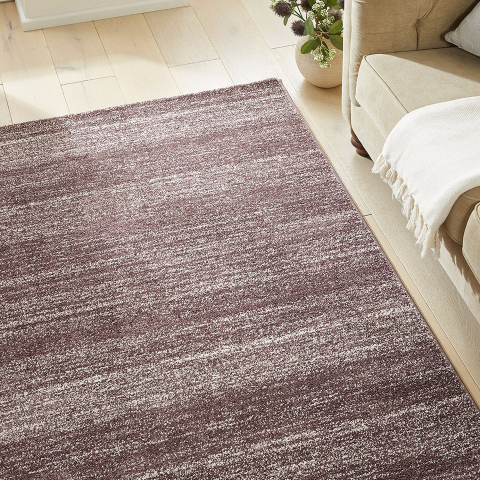plum striped rug in a living room with matching decor