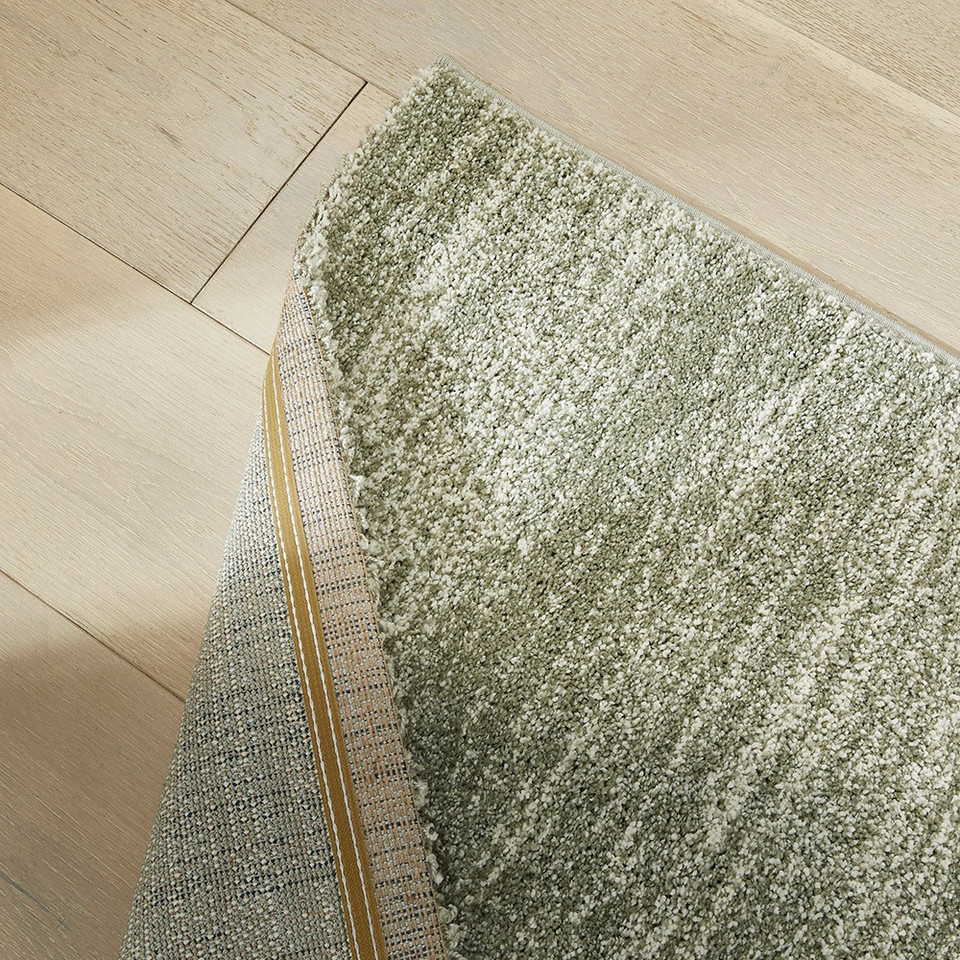 sage striped rug closeup corner folded