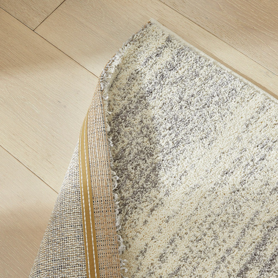 grey striped rug closeup closeup corner fold