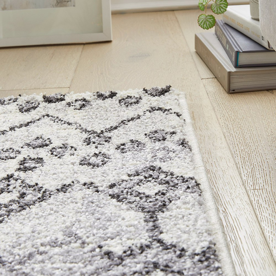 anthracite geometric rug corner with books