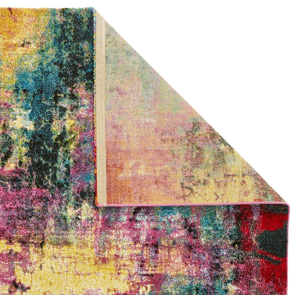 multicolour abstract rug closeup corner folded on white background