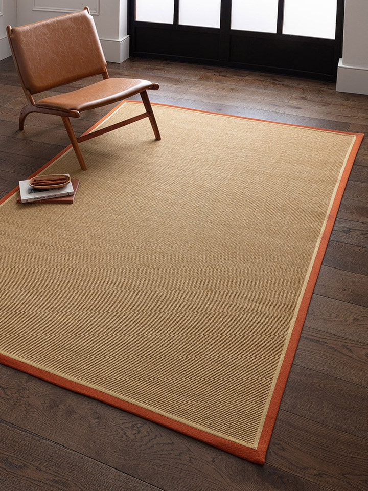 rust linen jute rug in a living room with matching decor