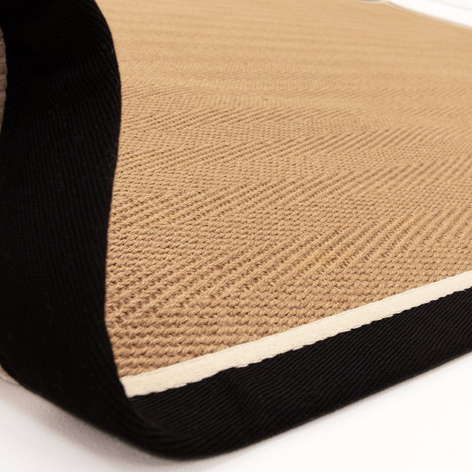 charcoal cream jute rug fold on white floor