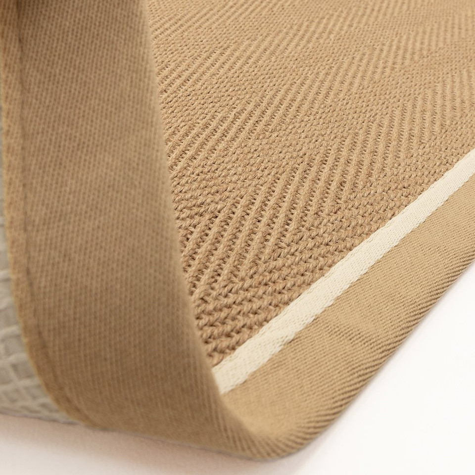 linen cream jute rug closeup fold on white floor