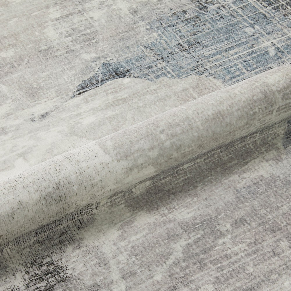 grey abstract rug closeup rolled