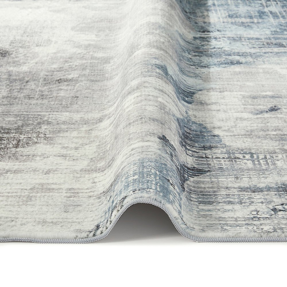 grey abstract rug closeup fold on white floor