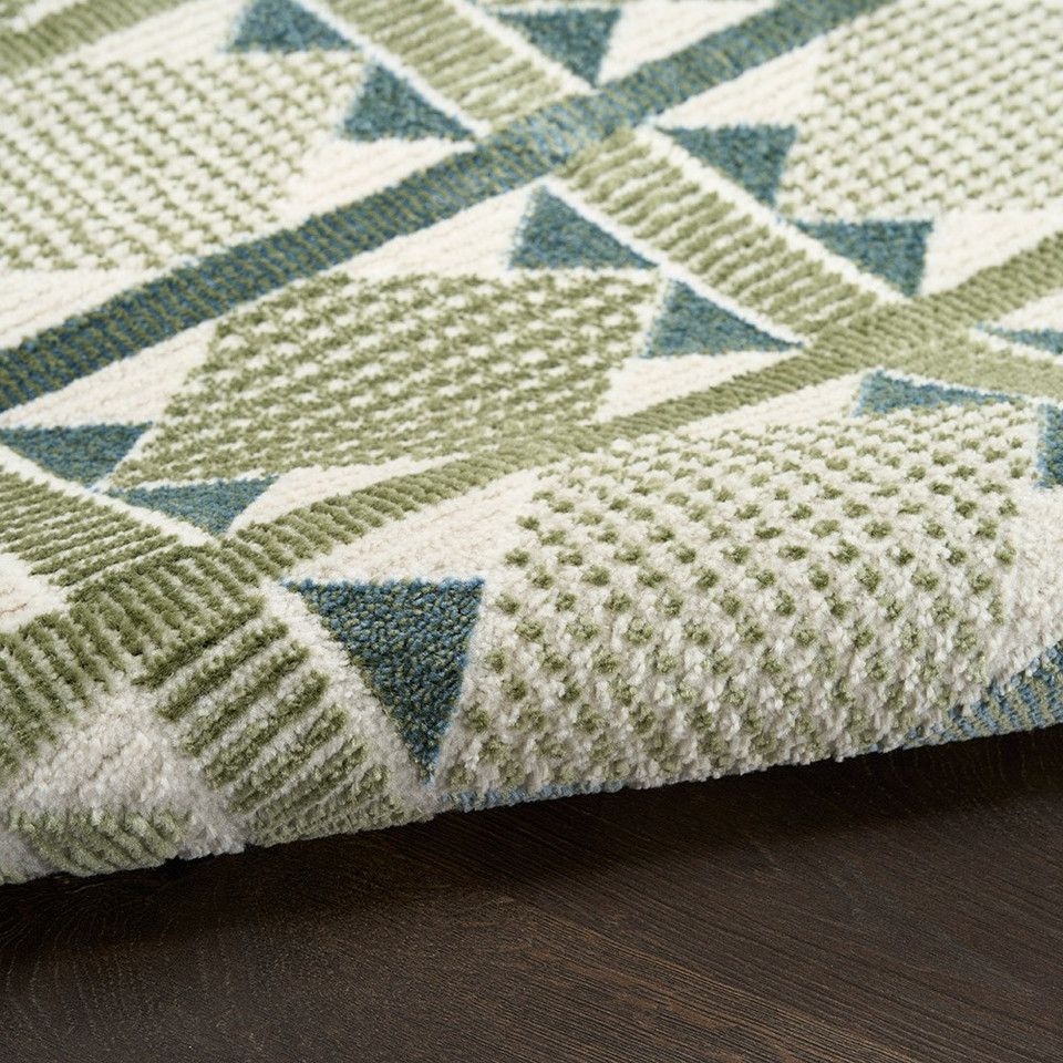 green blue geometric rug partially rolled