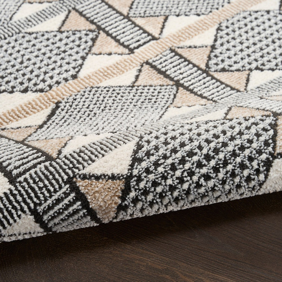 beige black geometric rug partially rolled