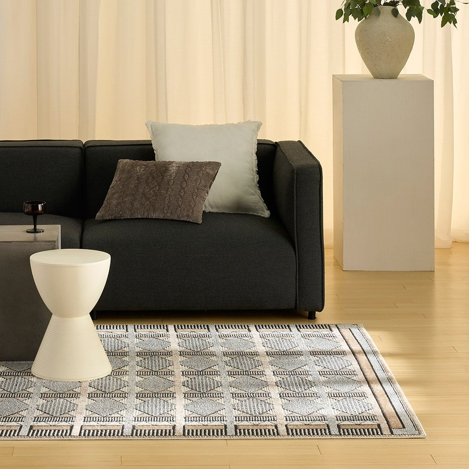 beige black geometric rug in a living room