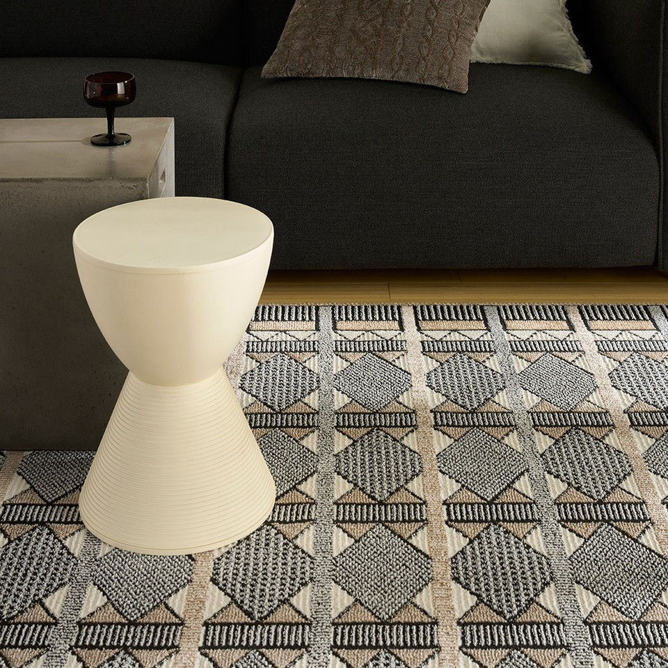 beige black geometric rug in a living room