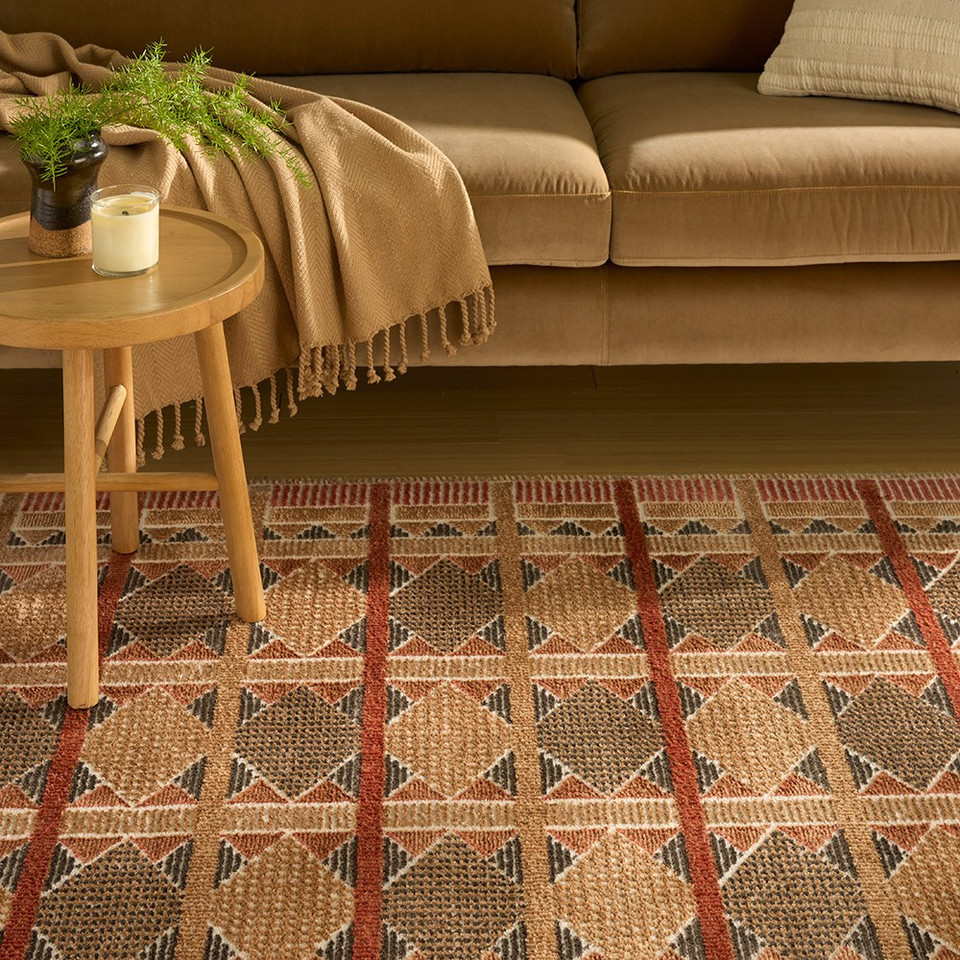 rust blue geometric rug in a living room
