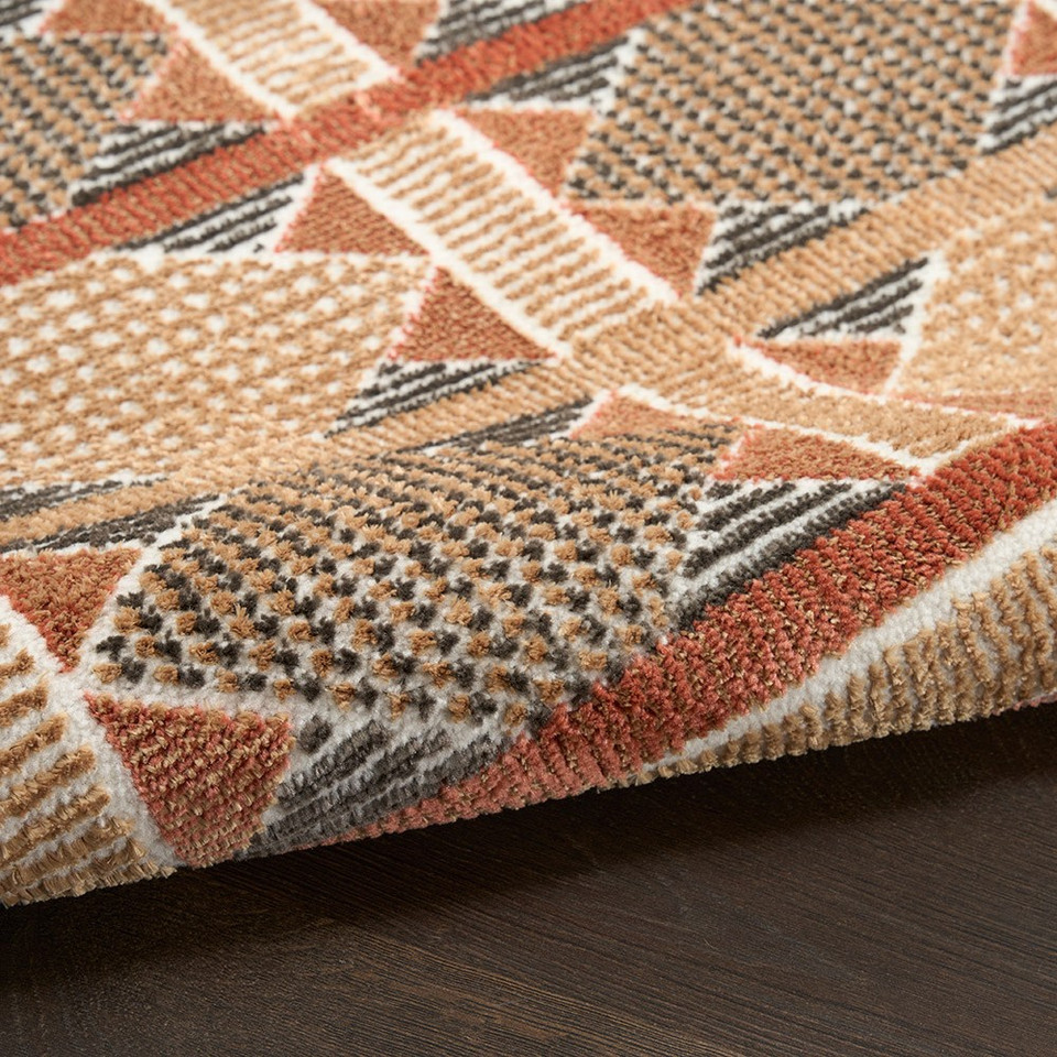 rust blue geometric rug partially rolled