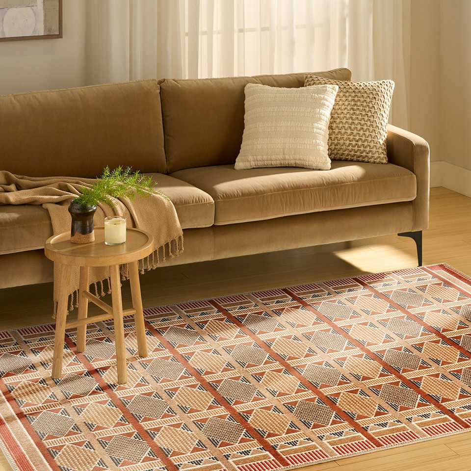 rust blue geometric rug in a living room