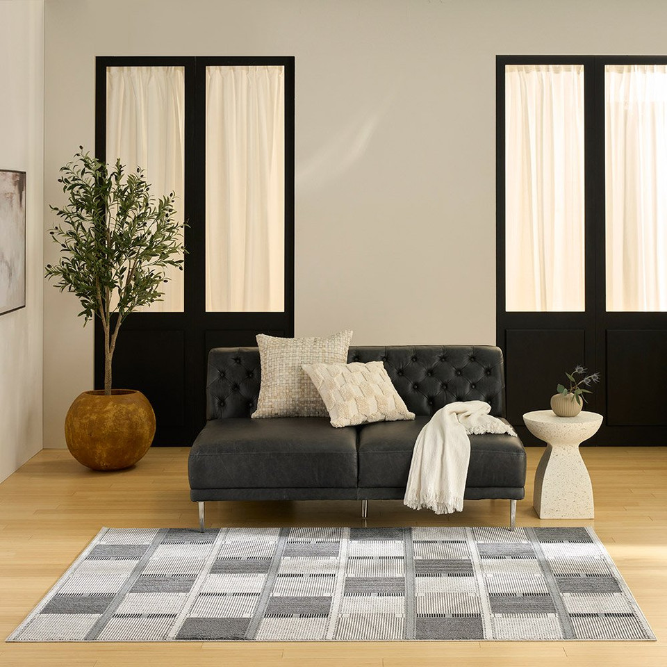 grey black geometric rug in a living room