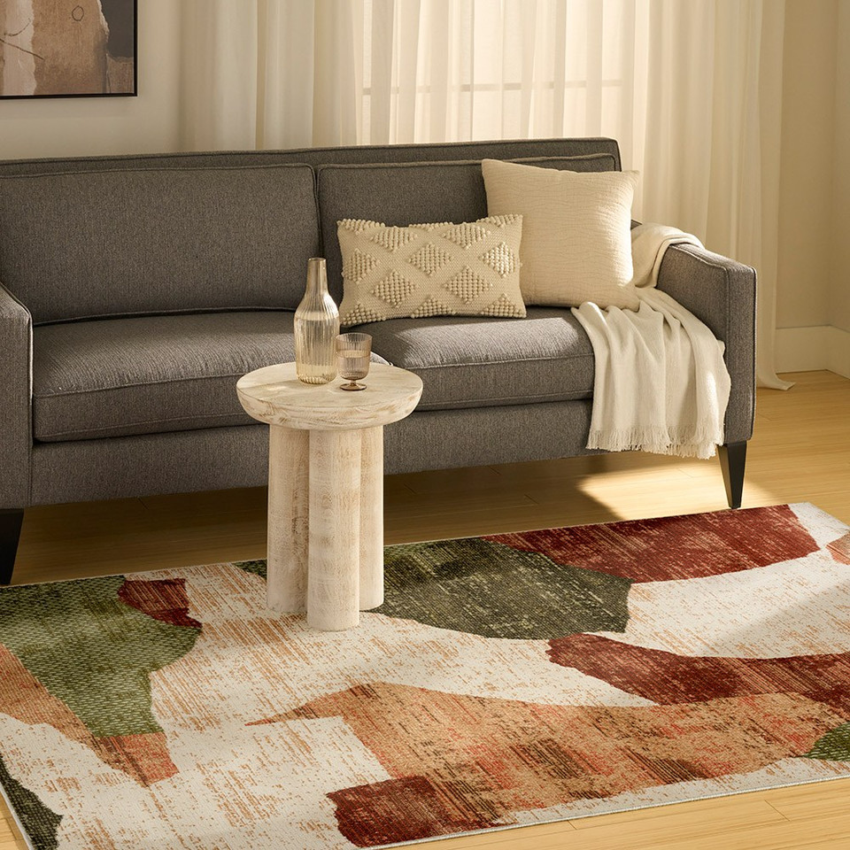 beige green burgundy geometric rug in a living room
