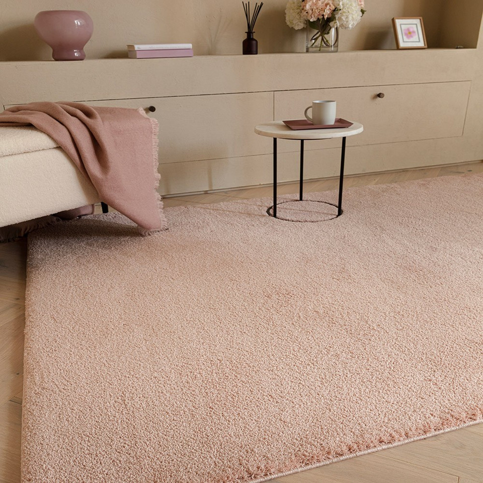 pink plain shaggy rug in a living room with matching decor