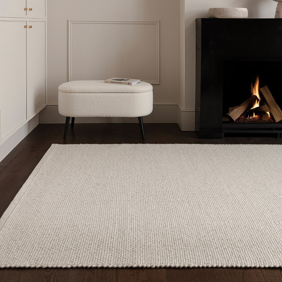 grey plain flatweave rug in a living room with matching decor