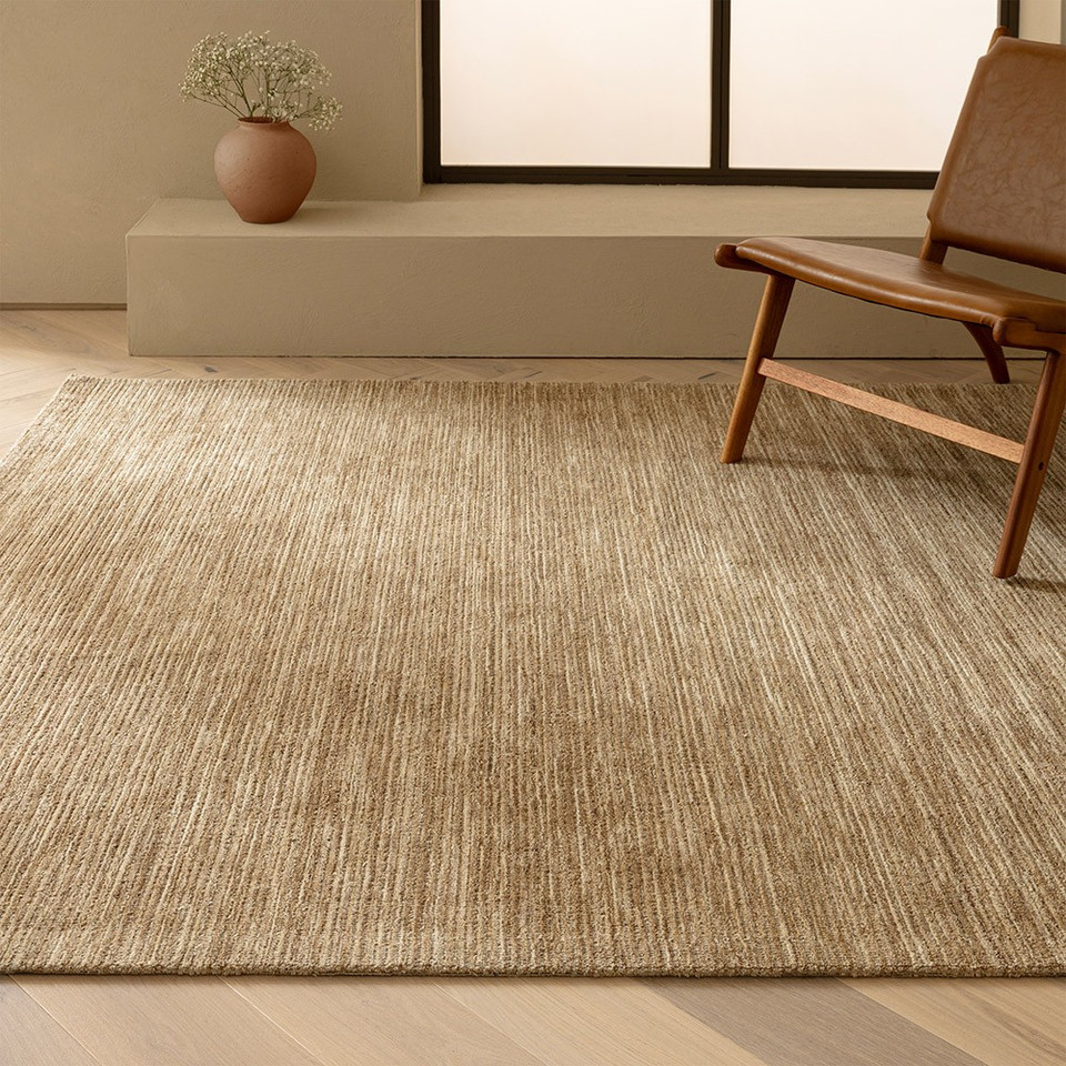 beige plain rug in a living room with matching decor