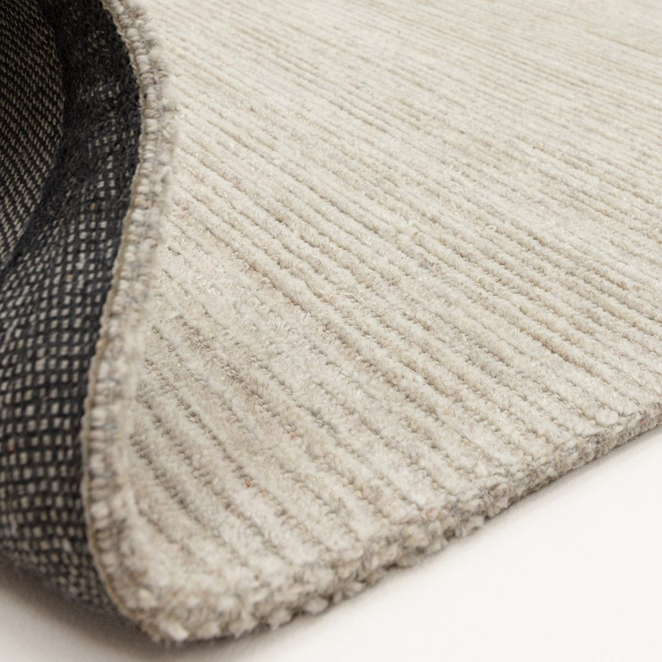 putty plain rug partial fold on white floor