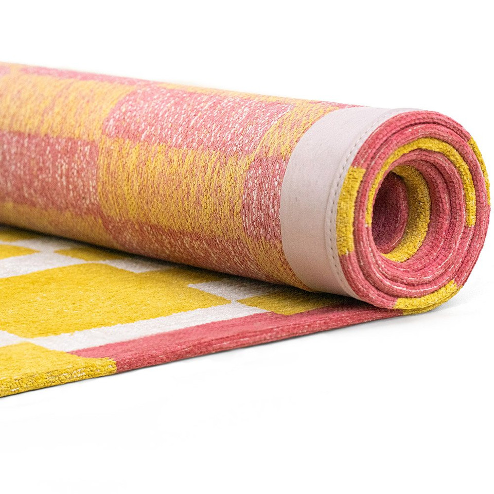 yellow chess eco rug rolled on white floor