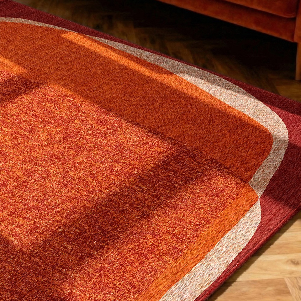orange abstract eco rug in a bedroom room with matching decor