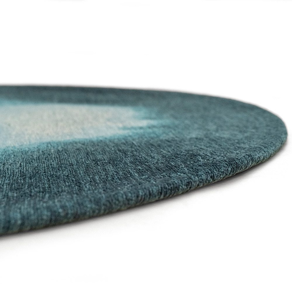 blue peanut shape rug closeup of edge on white floor