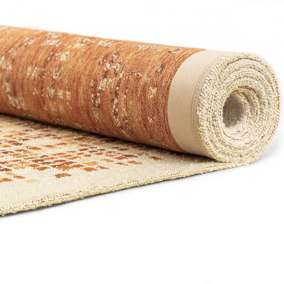 orange abstract rug rolled on white floor
