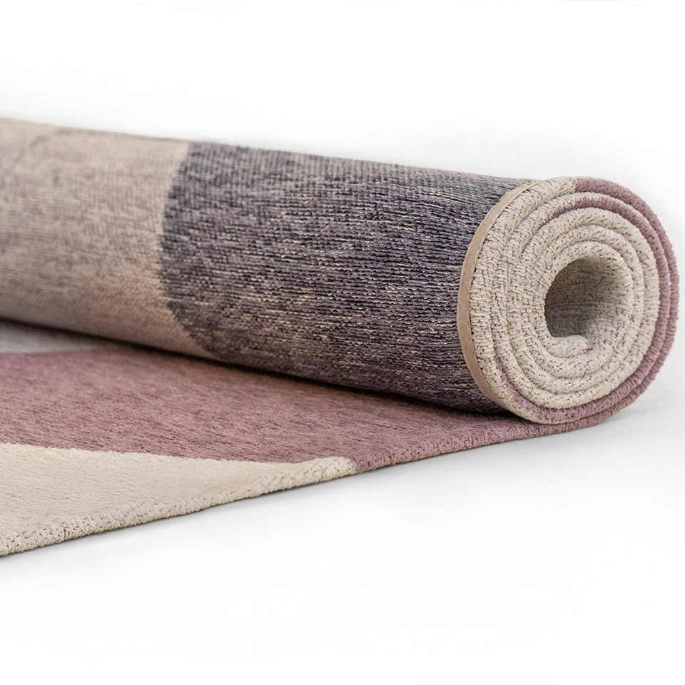 purple abstract rug rolled on white floor