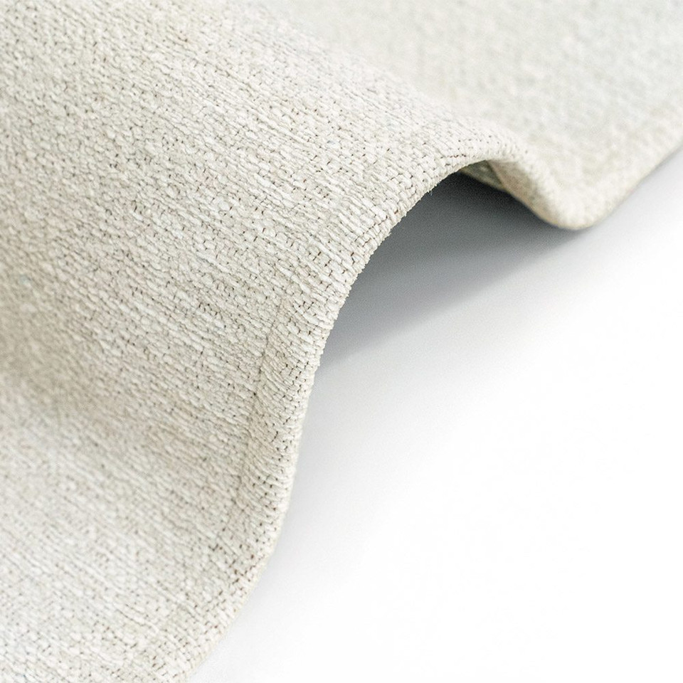 beige abstract rug folded on white floor