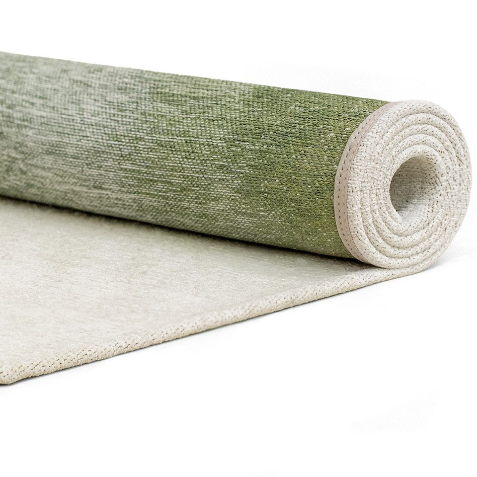 green abstract rug rolled on white floor