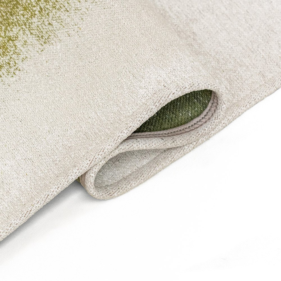 green abstract rug folded on white floor