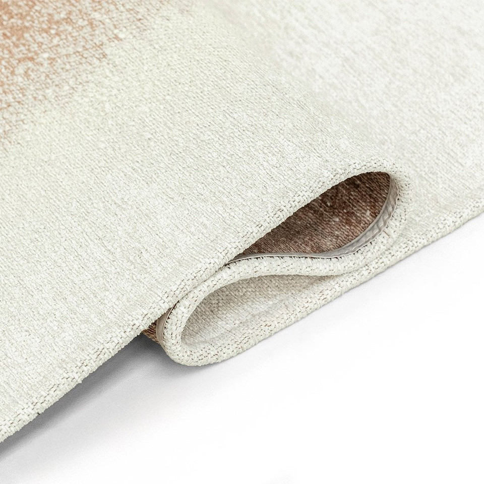 brown abstract rug folded on white floor