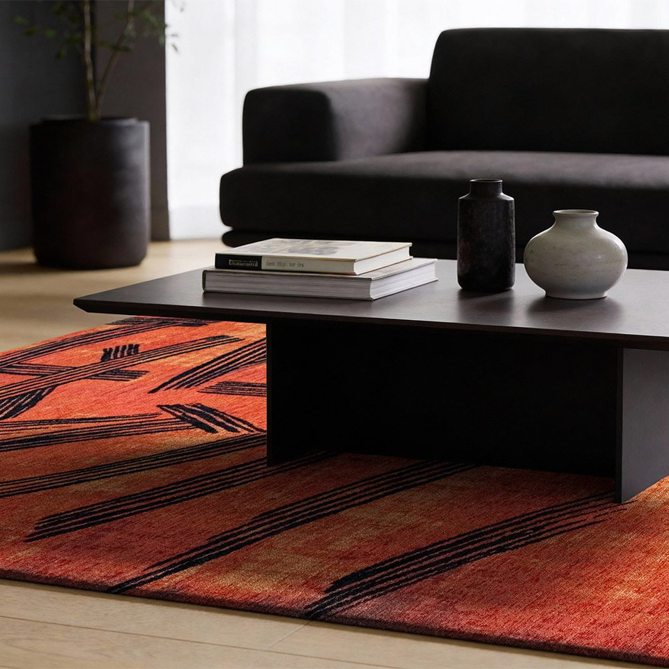 orange abstract rug in a living room with matching decor