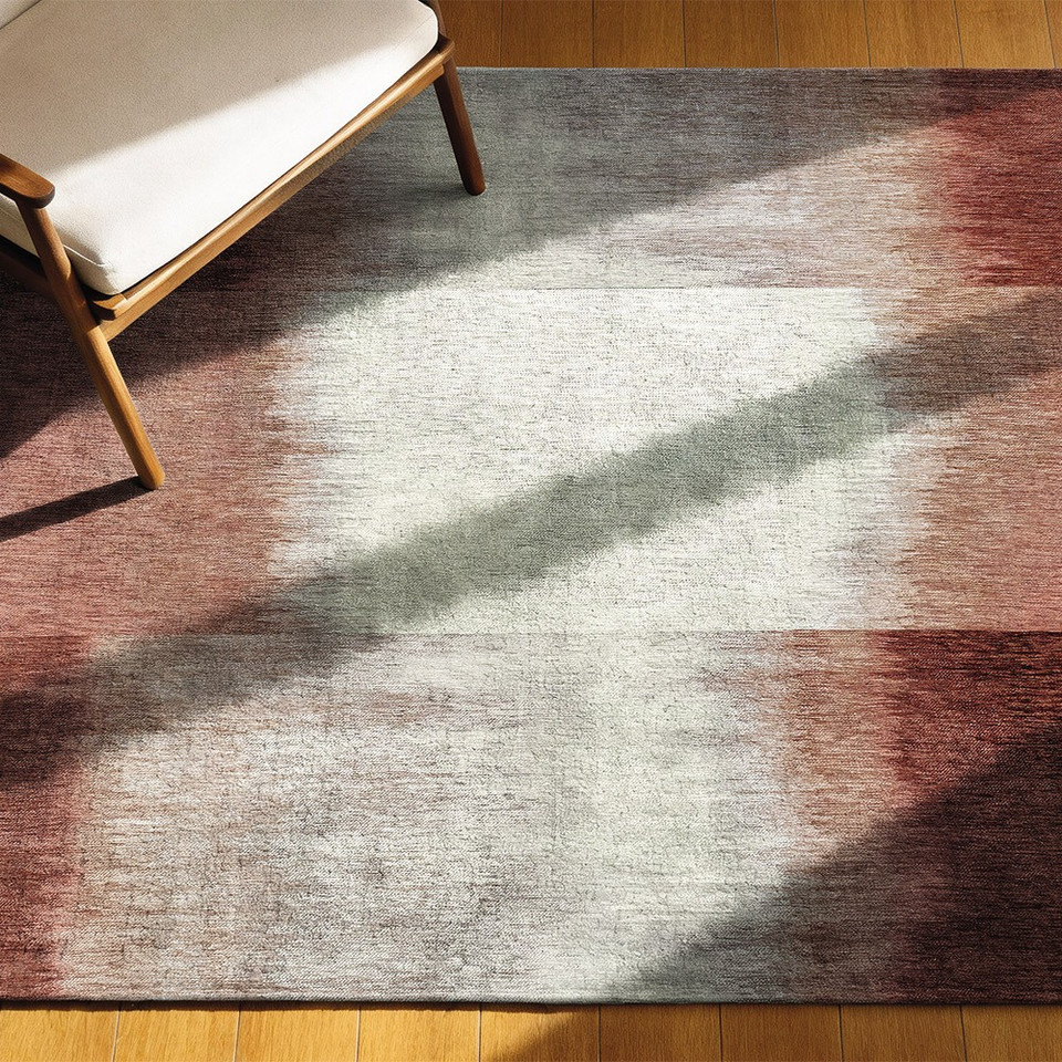 red abstract rug in a living room with matching decor