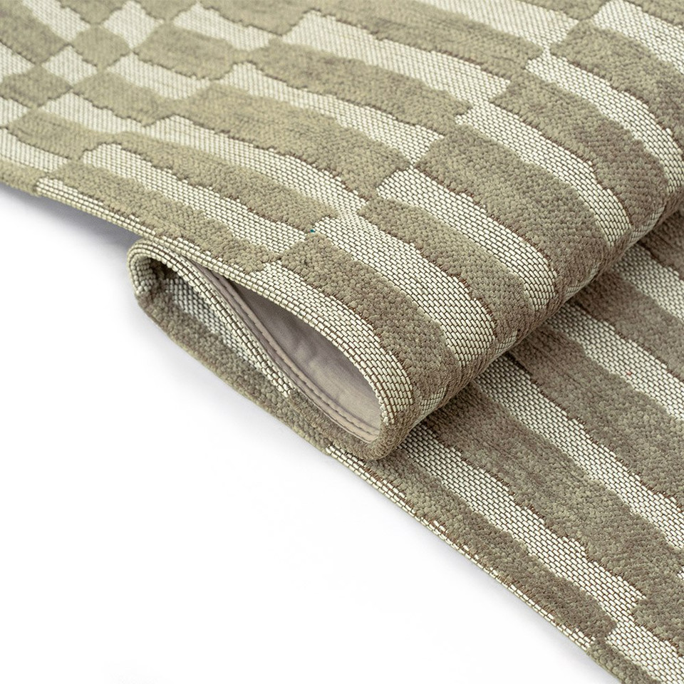 green abstract eco rug partially folded on white floor