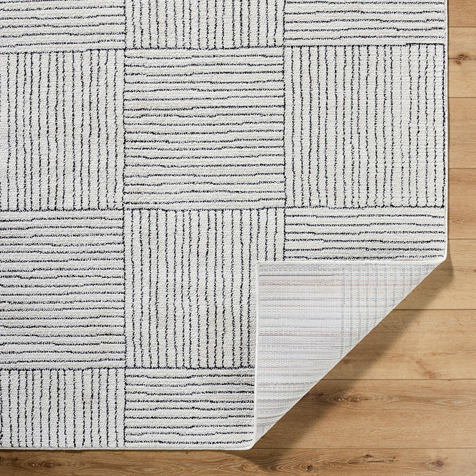 ivory black scandi rug corner fold on wood floor