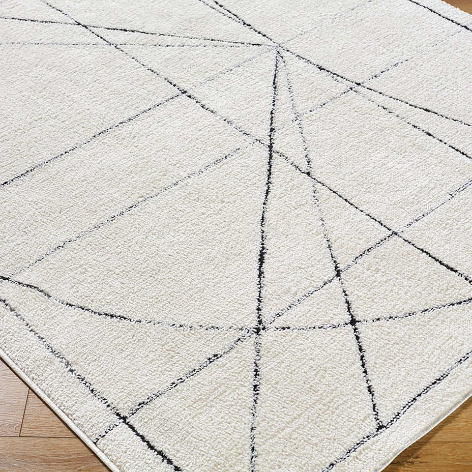 black ivory scandi rug closeup corner on wood floor