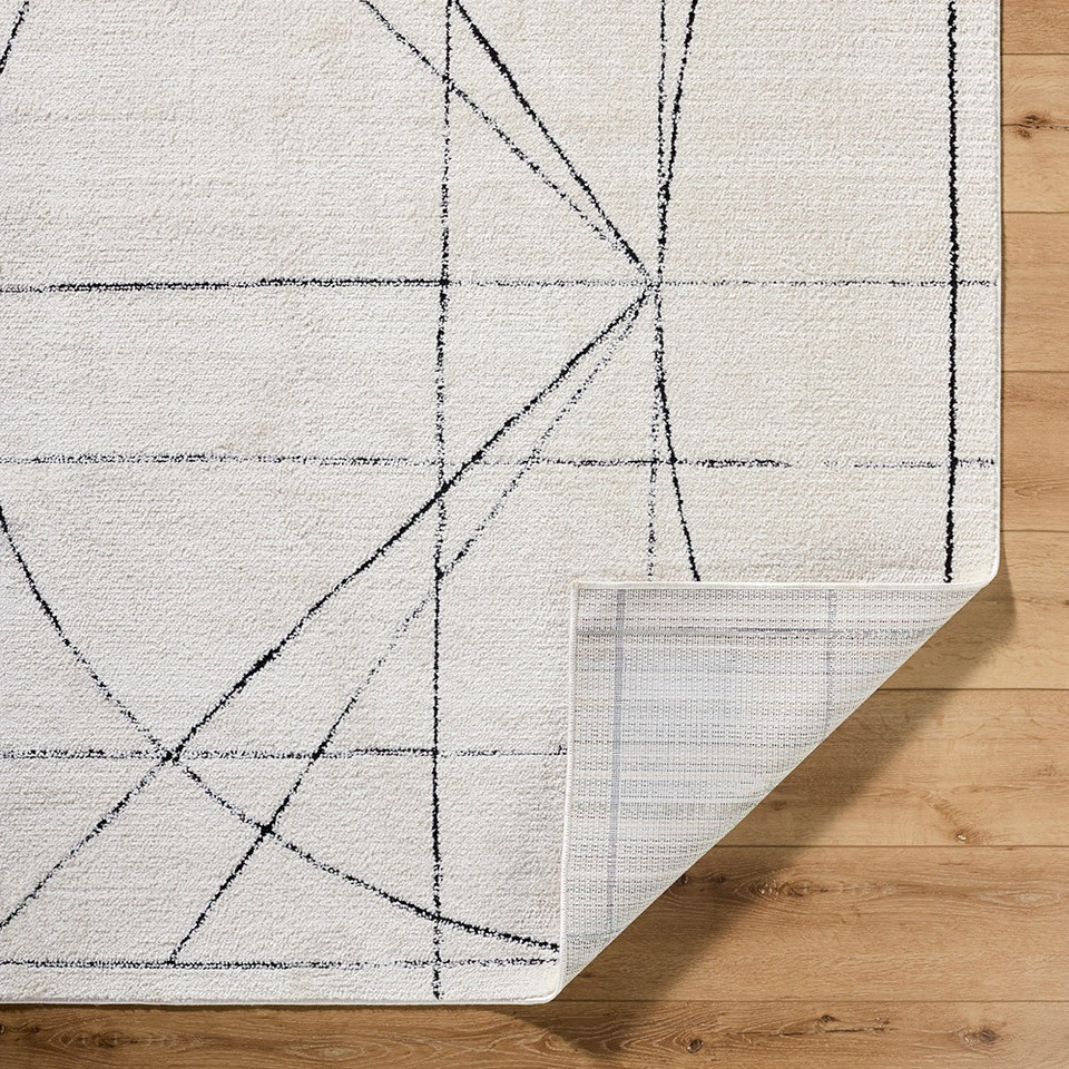 black ivory scandi rug corner fold on wood floor