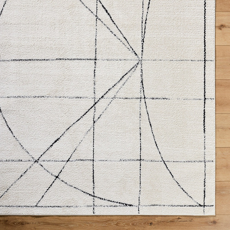 black ivory scandi rug closeup corner on wood floor