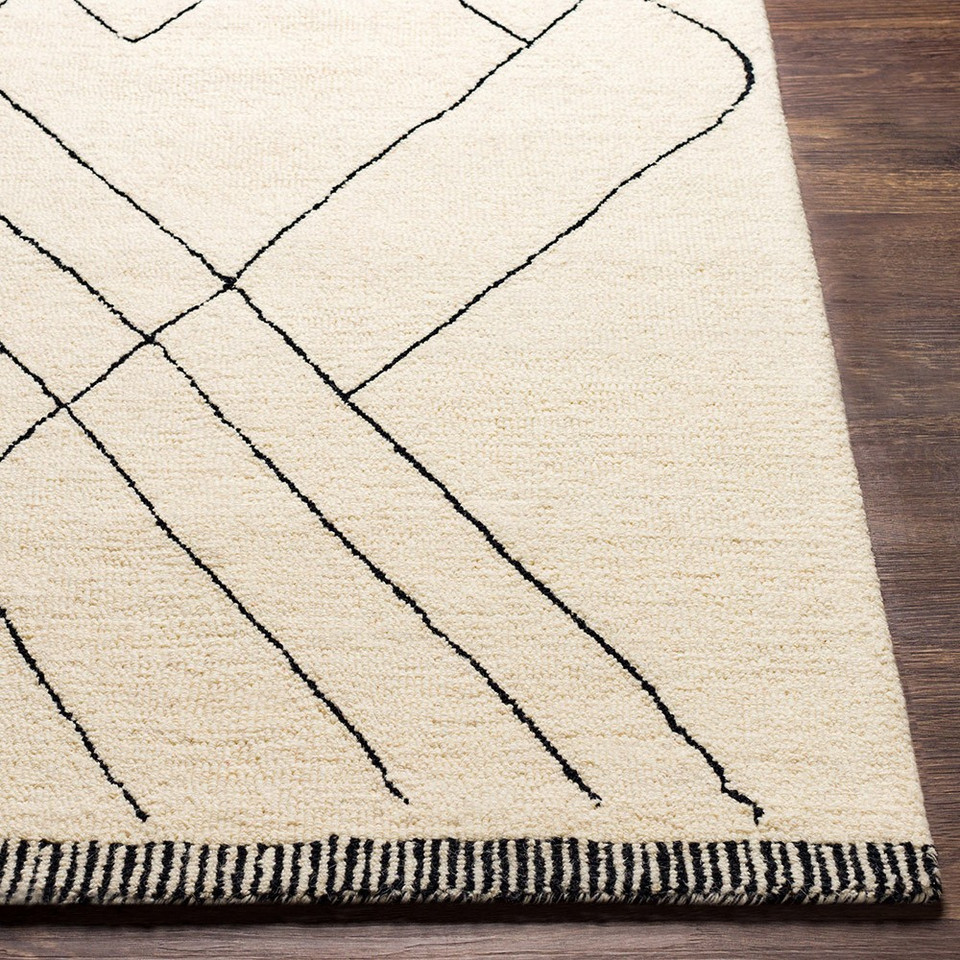 cream wool rug closeup corner on wood floor