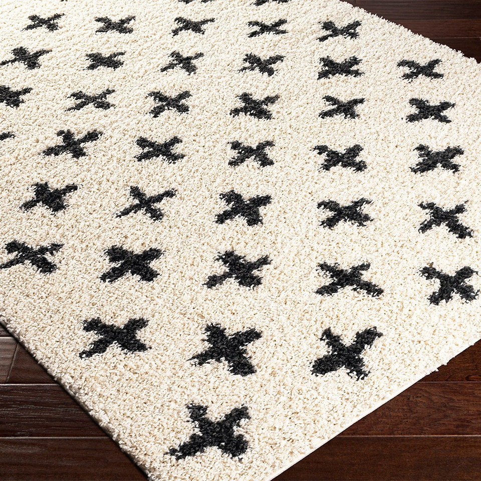 cream shaggy rug closeup corner on wood floor