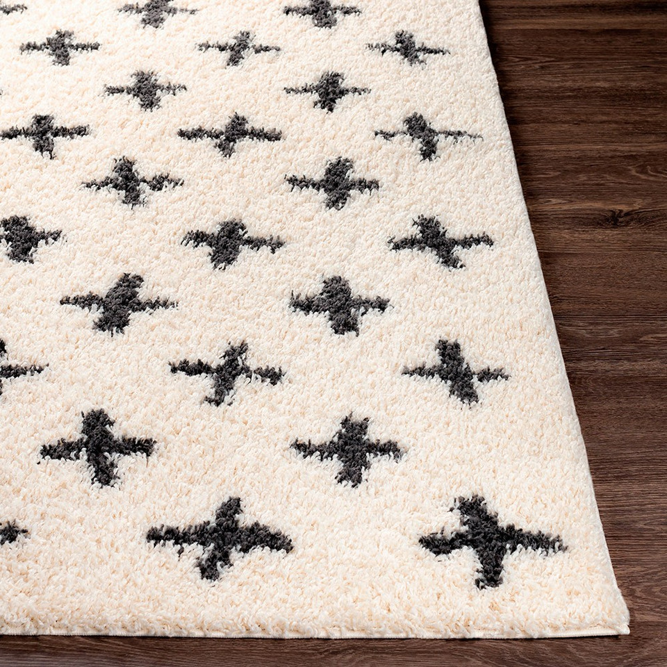 cream shaggy rug closeup corner on wood floor