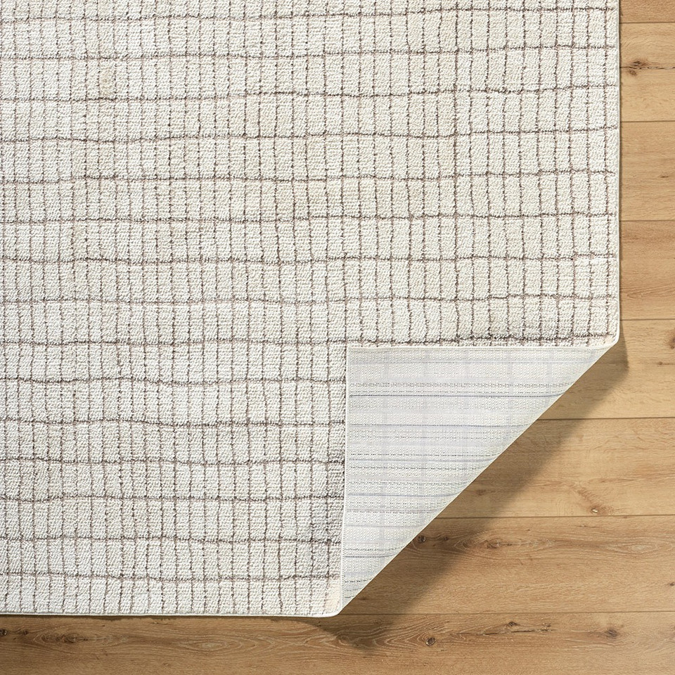 ivory taupe rug corner fold on wood floor