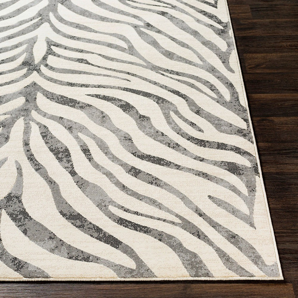 charcoal zebra pattern rug closeup corner on a wood floor