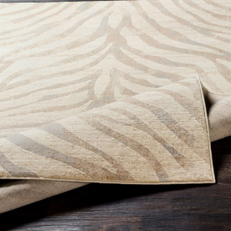 grey zebra pattern rug closeup corner fold on wood floor