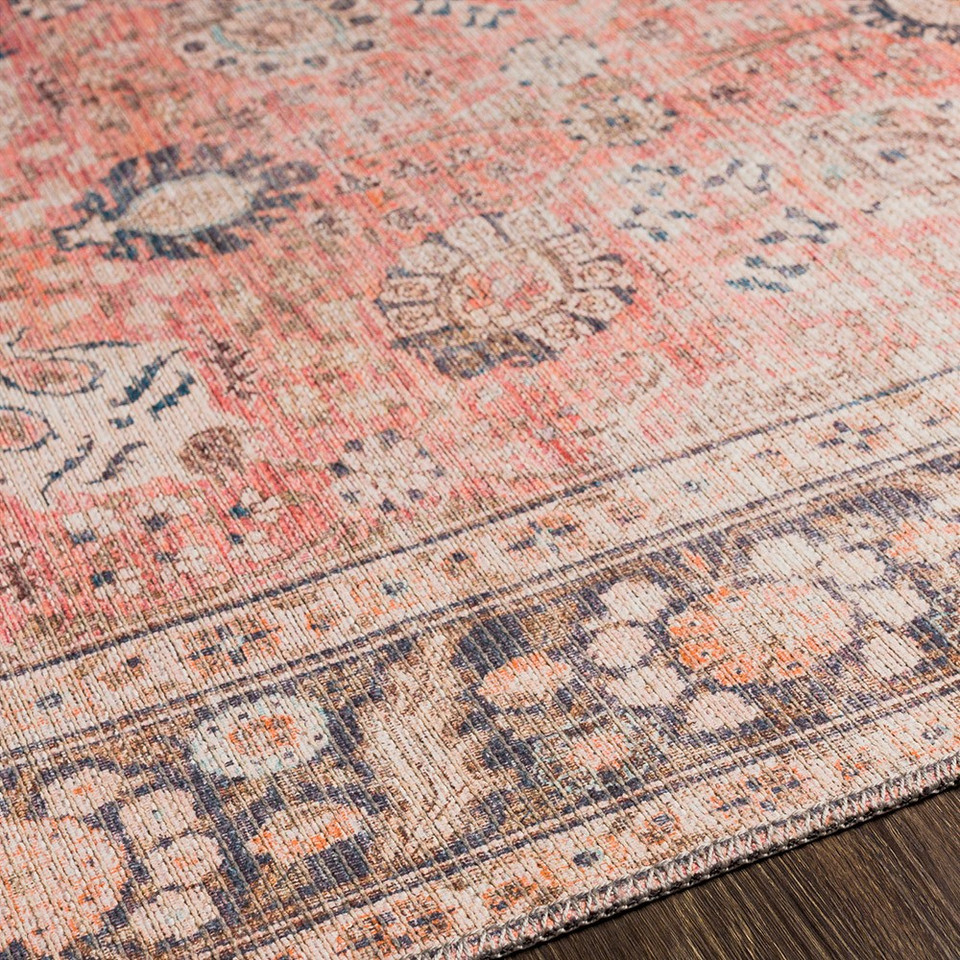 orange traditional rug closeup detail on wood floor
