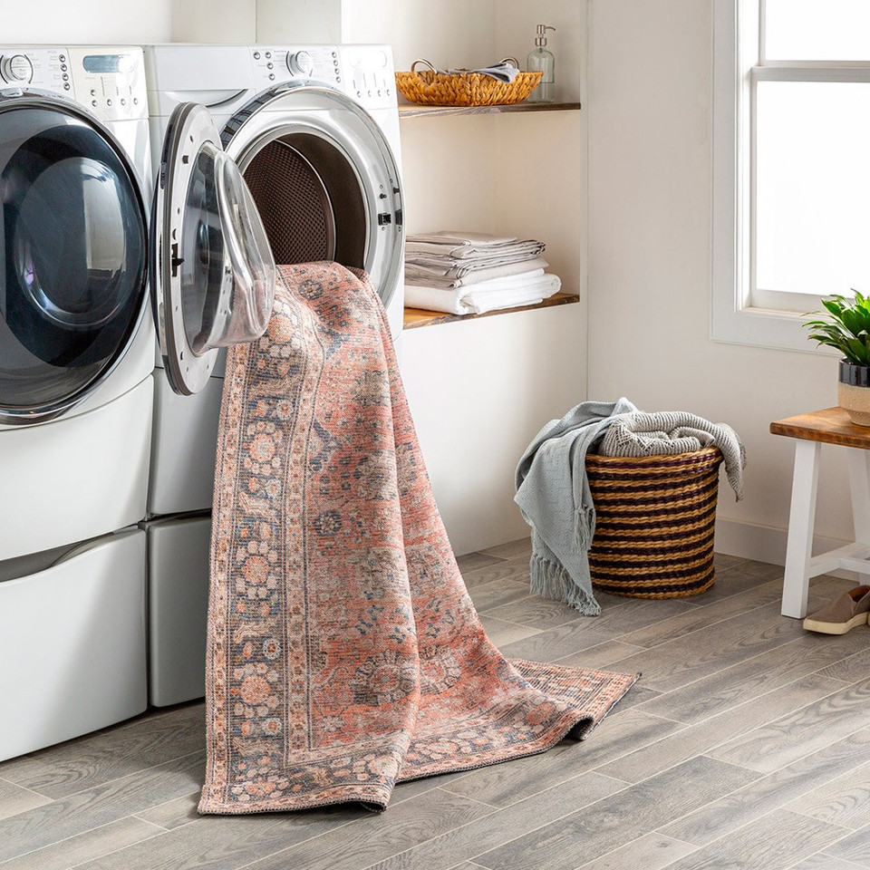 orange traditional rug in washing machine in a utility room