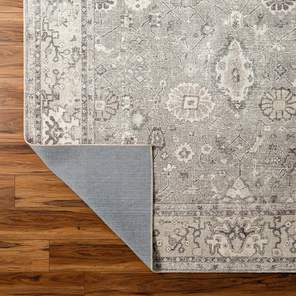 brown traditional rug corner folded on wood floor